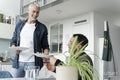 Male couple eating breakfast at home