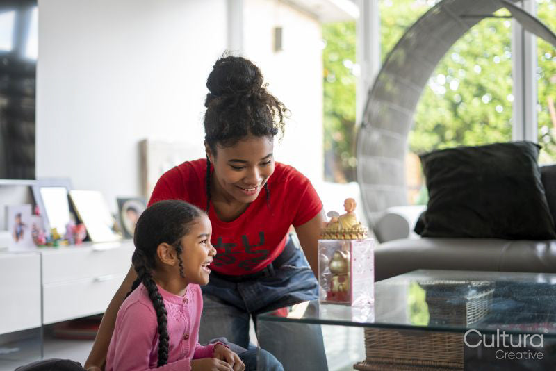 Two sisters playing at table in living room