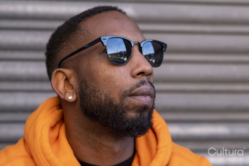 South Yorkshire, Close-up of man in yellow hooded shirt and sunglasses