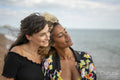 Female couple being close on beach