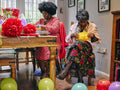 Women making paper decorations for party
