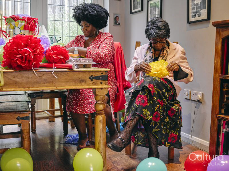Women making paper decorations for party