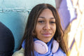South Yorkshire, Close-up of woman with headphones against colorful wall