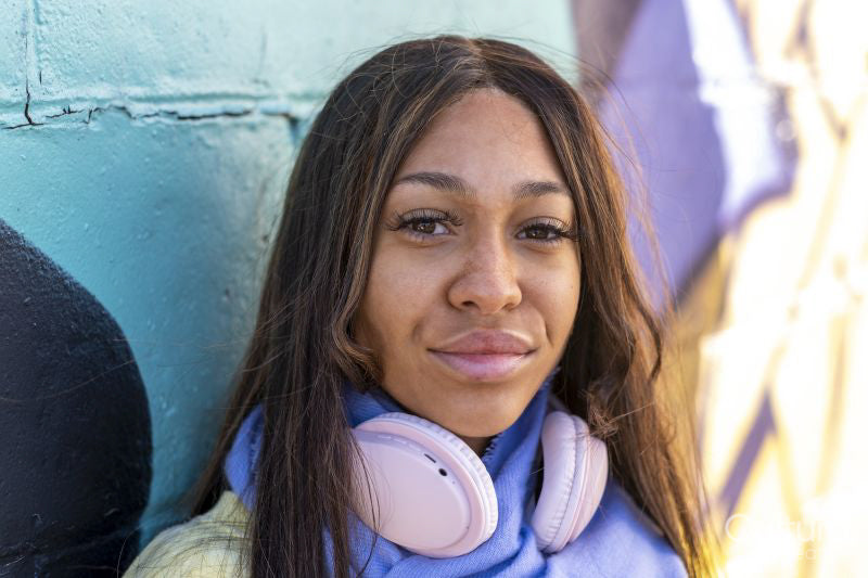 South Yorkshire, Close-up of woman with headphones against colorful wall