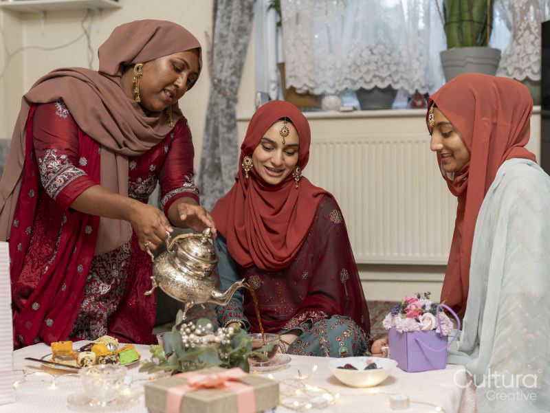 Woman pouring tea during Ramadan celebration at home
