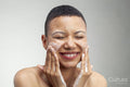 Portrait of smiling woman washing face