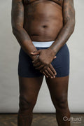 Mid section view of man wearing boxer shorts against gray background