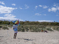 Girl holding kite on beach