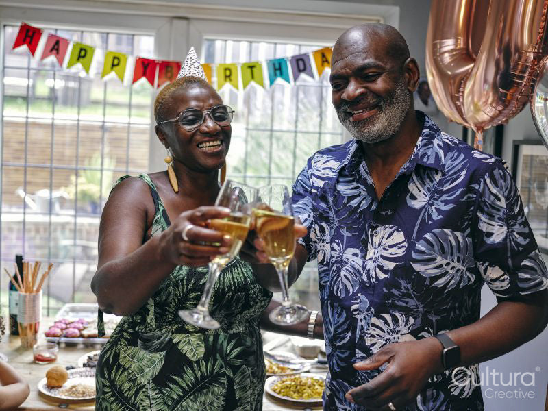 Mature couple celebrating with champagne at birthday party