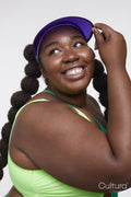 Studio shot of smiling young woman in vibrant clothing
