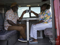 Senior couple drinking tea in camper van