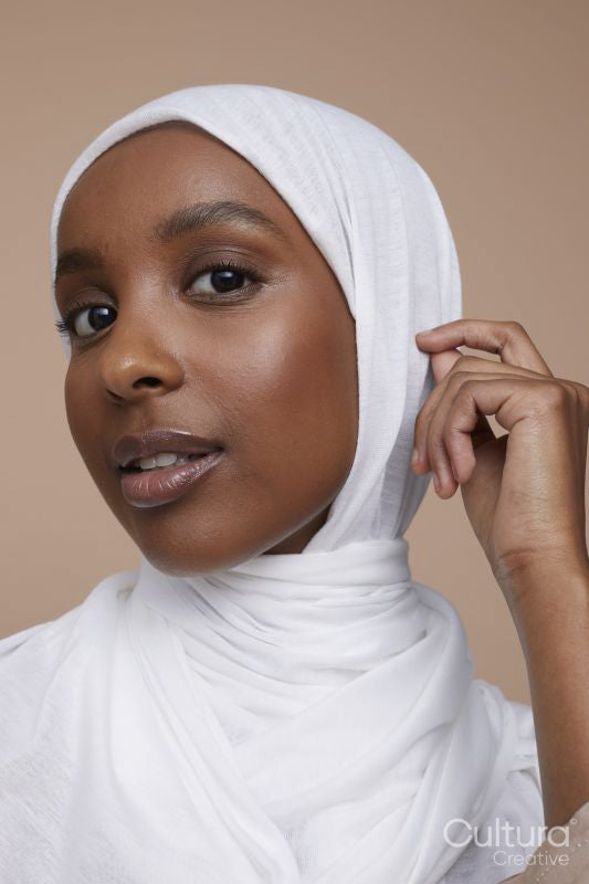 Studio portrait of young woman wearing white hijab