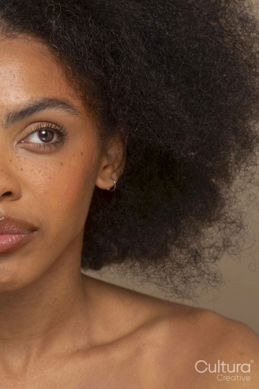 Close-up of woman with black frizzy hair