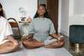 couple practicing yoga at home