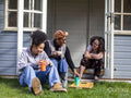 Mother with two daughters relaxing in backyard