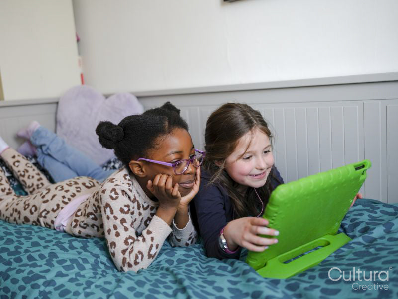 Girl friends using digital tablet at home