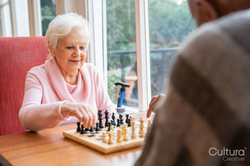 Senior people playing chess in nursing home
