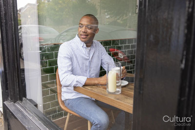 Man enjoying coffee at cafe table