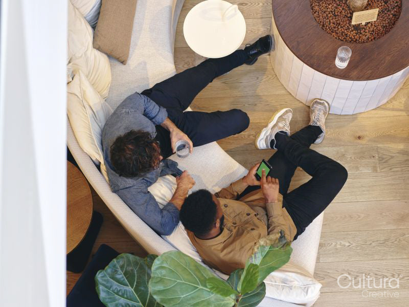 Overhead view of coworkers relaxing in office lobby