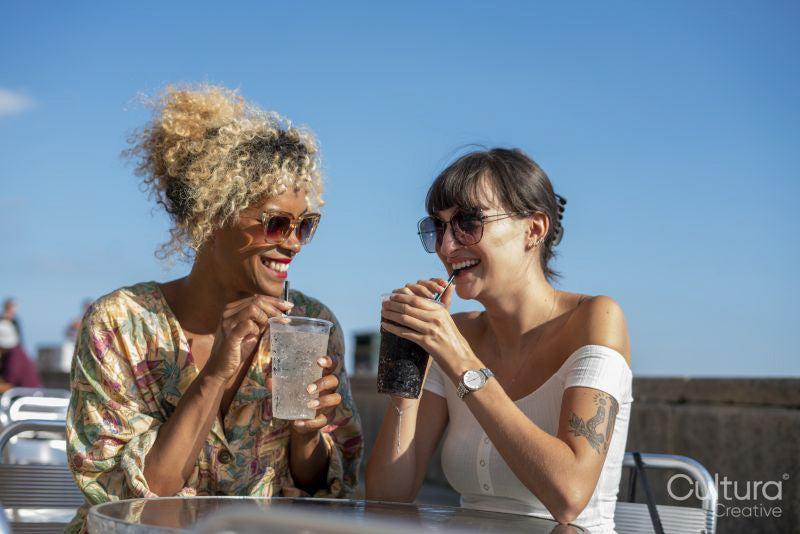 Female couple having dreams in outdoor cafe