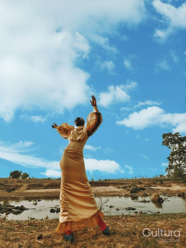 Fashion shot of young woman by river