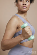 Studio portrait of woman exercising with dumbbells