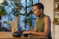 Woman sitting at table and using laptop