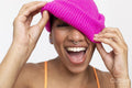 Studio portrait of smiling woman in pink woolen cap