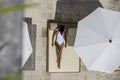 Overhead view of woman relaxing on poolside