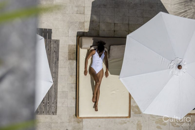 Overhead view of woman relaxing on poolside