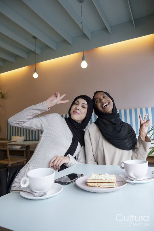 Portrait of young female friends meeting in cafe