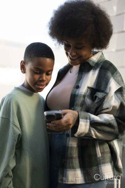 Smiling mother and son using smart phone