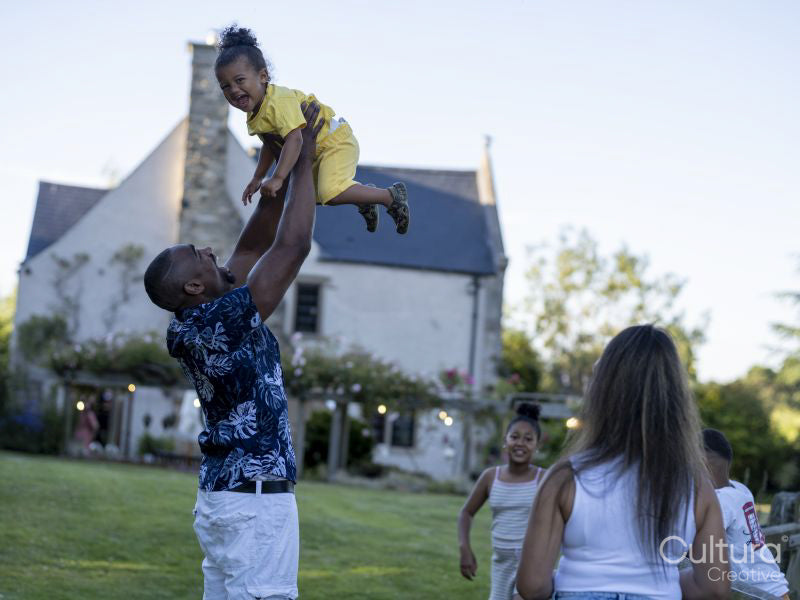 Family with children playing in garden