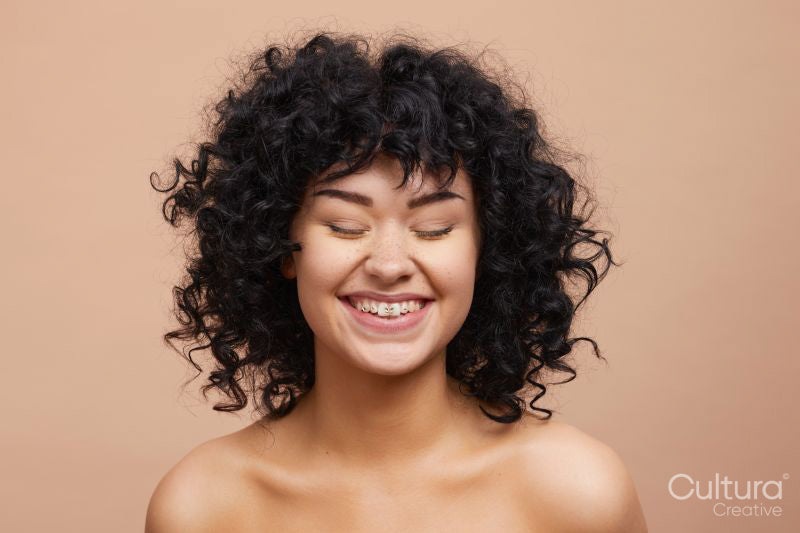 Studio portrait of beautiful laughing woman