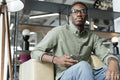Young man sitting in office lounge