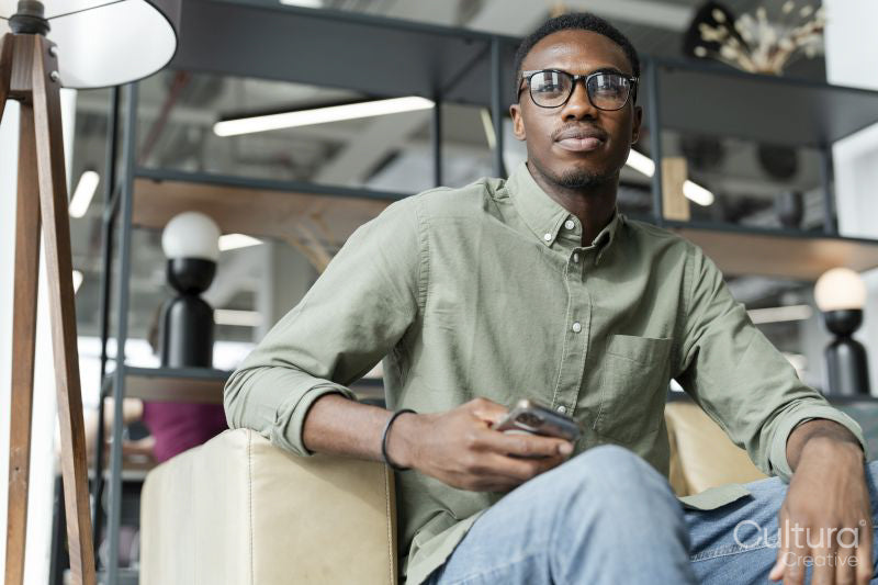 Young man sitting in office lounge