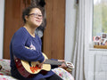 Girl with Down syndrome playing ukulele