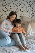 Mother and son using digital tablet in bedroom