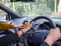Woman and girl in car, view of hands