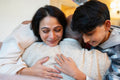 Mature woman and boy hugging senior man during visit in nursing home