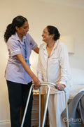 Nurse helping senior lady in her room at nursing home