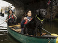 Women and dog canoeing in canal