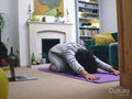 Woman practicing yoga at home