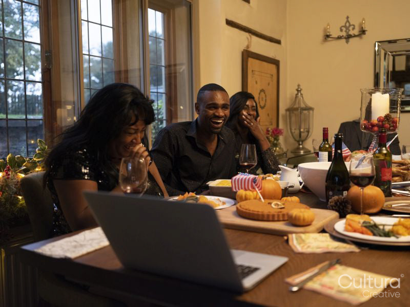 Family having video call during Thanksgiving dinner