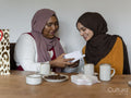 Woman looking at gift with friend
