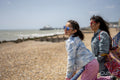 Mother and daughter relaxing on beach