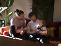 couple playing with baby daughter in living room