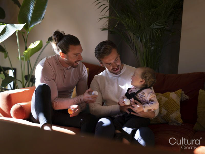 couple playing with baby daughter in living room
