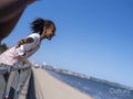 Girl looking at sea with outstretched arms