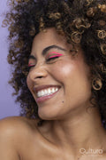 Smiling woman with pink makeup